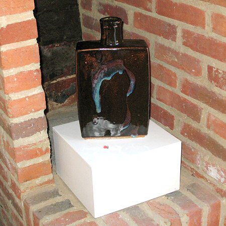 Temmoku glazed moulded bottle with copper pour