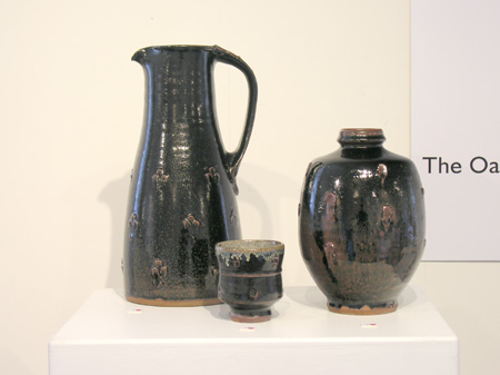 Temmoku glazed pots with pelleted decoration, tall jug, yunomi and bottle vase