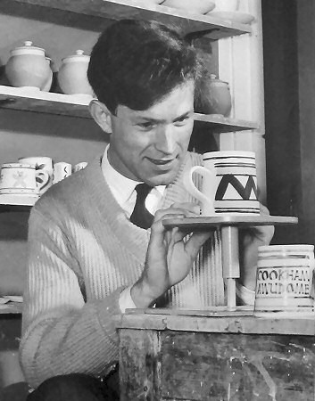 A young Reg decorating a mug