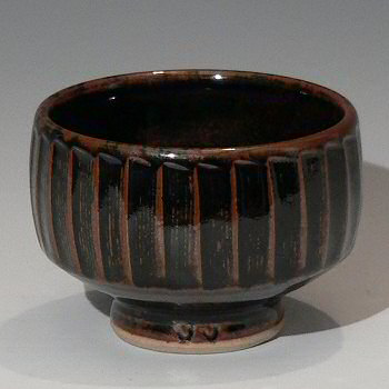 Facetted Stoneware Tea Bowl with green flash inside.
